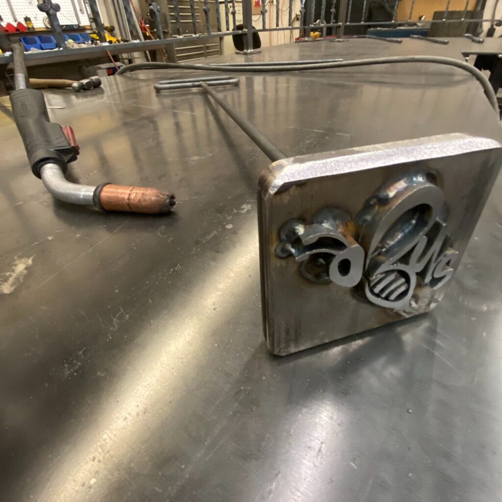 Custom fabricated leather branding tool by Dream Ironwork, designed in the shape of a bee, crafted from durable metal for precise and detailed leather imprinting.