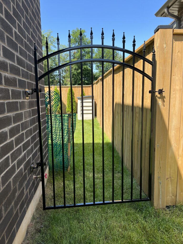 Custom wrought iron gate with spear tops and full arch feature.