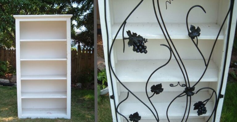 White bookshelf stands outdoors near white siding and decorative metalwork with grapevine design.
