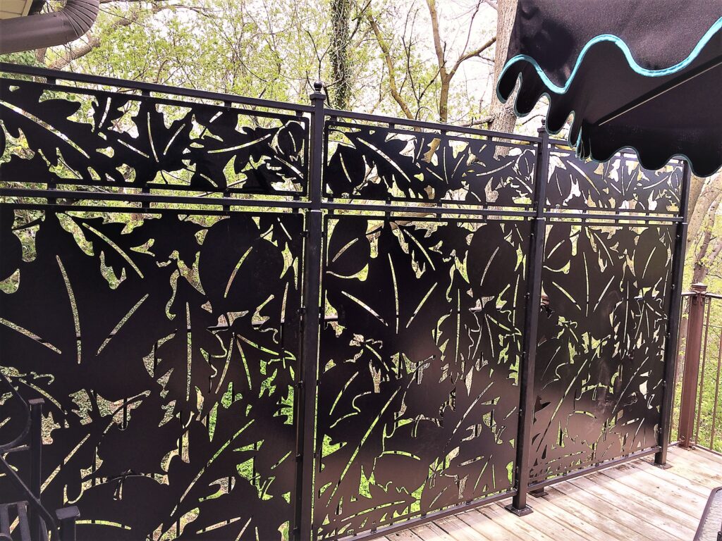 Decorative black metal fence with leaf patterns, laser cut design custom made. With steel frame.