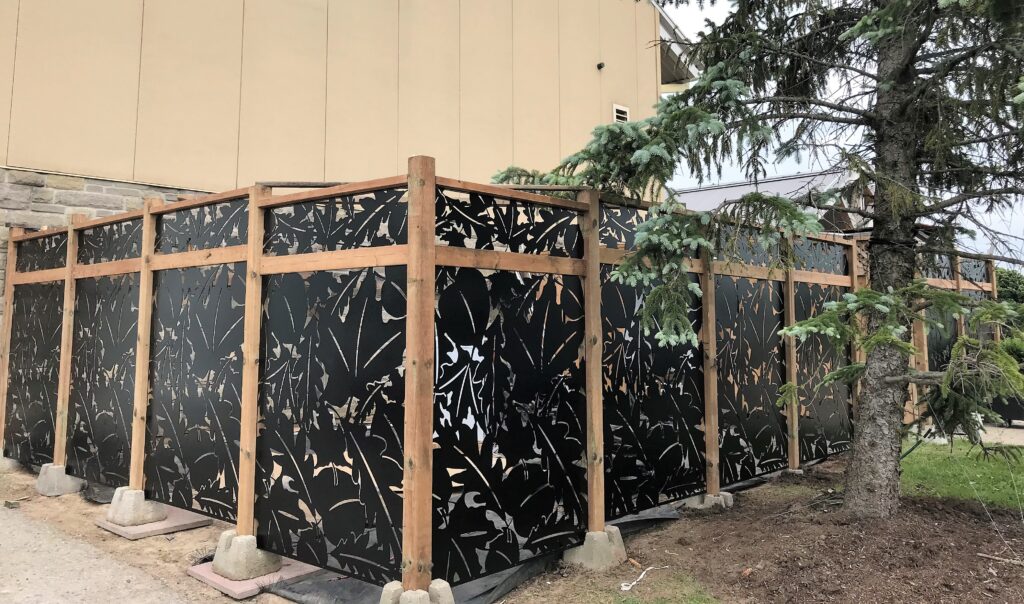 Decorative black metal fence with leaf patterns, laser cut design custom made. With steel frame.