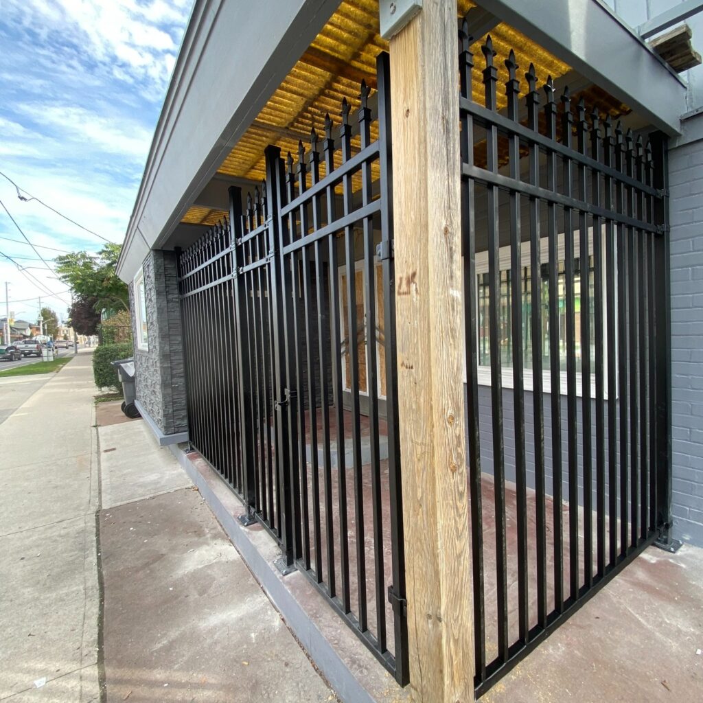 Custom fabricated commercial steel fence by Dream Ironwork featuring decorative spear finials, heavy-duty welded construction, and a durable powder-coated finish for security and curb appeal.