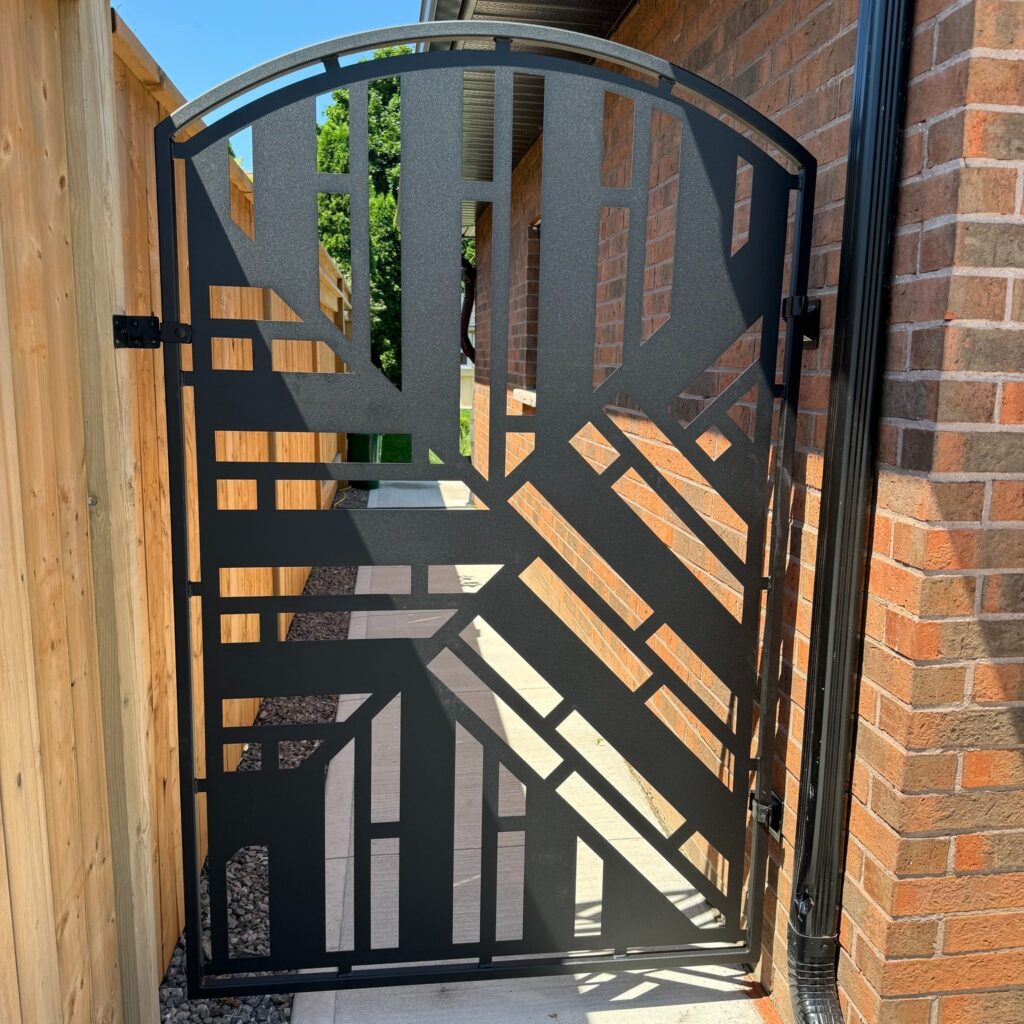 Modern backyard gate with geometric design. Laser cut gate for pet safety, powder coated black.