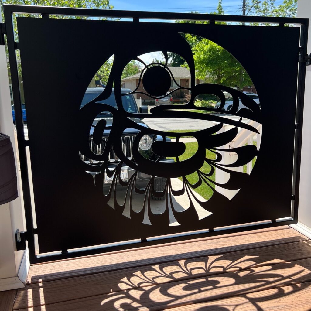 Custom fabricated laser-cut iron pet gate for a front porch by Dream Ironwork, featuring precise detailing, durable welded construction, and modern design for secure residential entryways.
