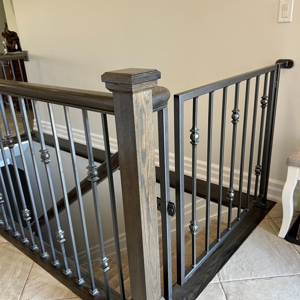 Custom fabricated interior iron baby gate with a wooden accent by Dream Ironwork, featuring precision construction, smooth operation, and a modern, durable design for safe and stylish home interiors.