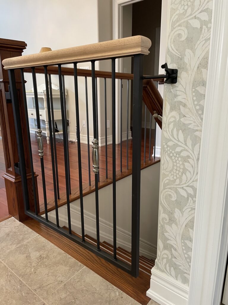 Custom fabricated interior iron baby gate with a wooden accent by Dream Ironwork, featuring precision construction, smooth operation, and a modern, durable design for safe and stylish home interiors.