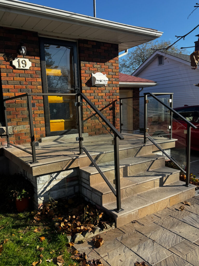 Custom glass and metal railing solution for a front porch exterior by Dream Ironwork, featuring durable welded construction, sleek modern design, and precision craftsmanship for enhanced safety and aesthetic appeal.