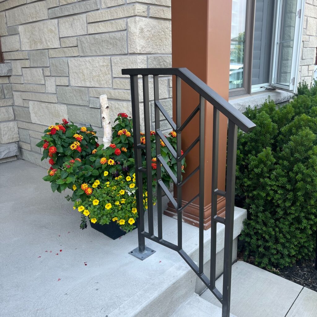 Modern herringbone railing design, metal railing powder coated on a front porch.