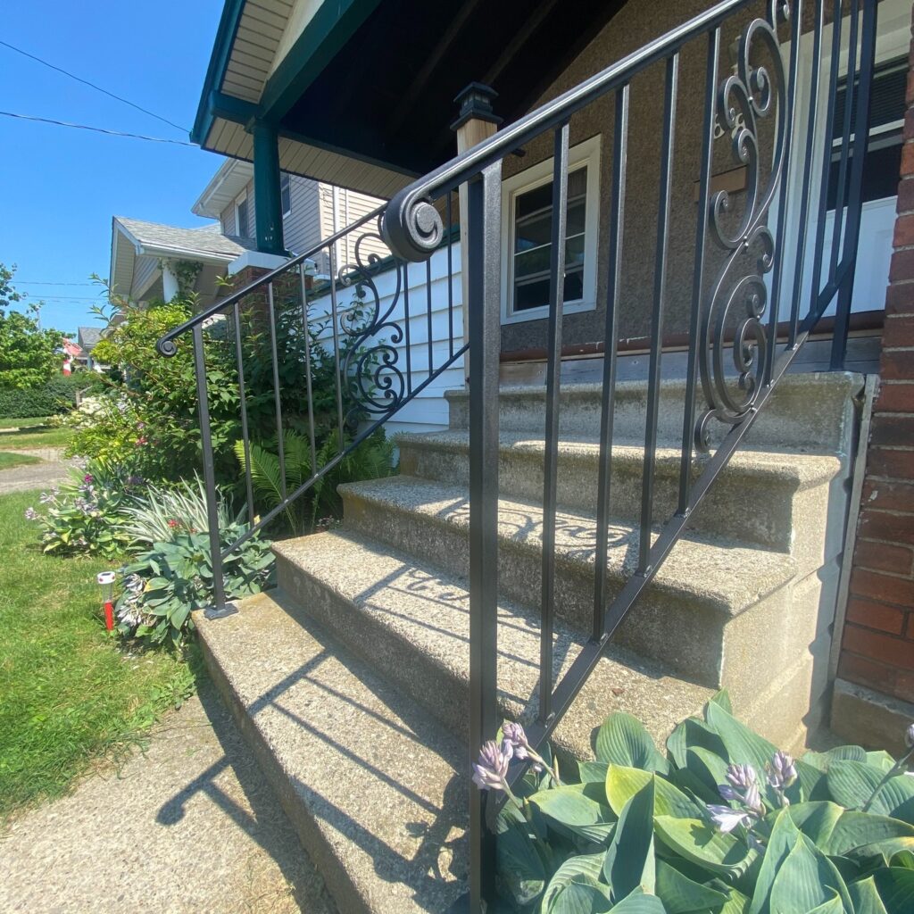 Custom fabricated traditional wrought iron railing by Dream Ironwork featuring decorative scrollwork as the central design element, handcrafted for durability, elegance, and classic architectural appeal.