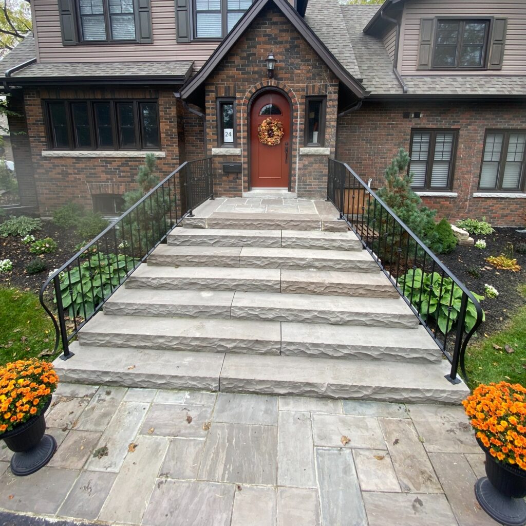 Custom fabricated wrought iron railing by Dream Ironwork featuring a large elongated lamb’s tongue ending, handcrafted for a smooth flowing profile and elegant traditional styling.