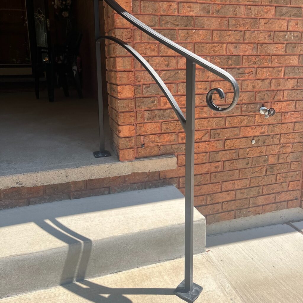 Custom curved railing on a front porch with large scroll ending and modern design. Powder coated black.