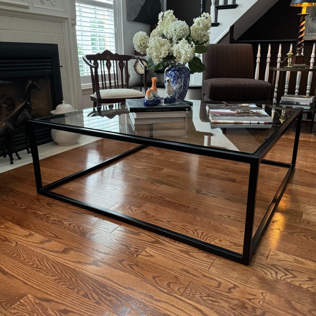 Custom fabricated modern metal and glass table by Dream Ironwork featuring a sleek metal frame and tempered glass top, designed for contemporary style, durability, and elegant functionality.
