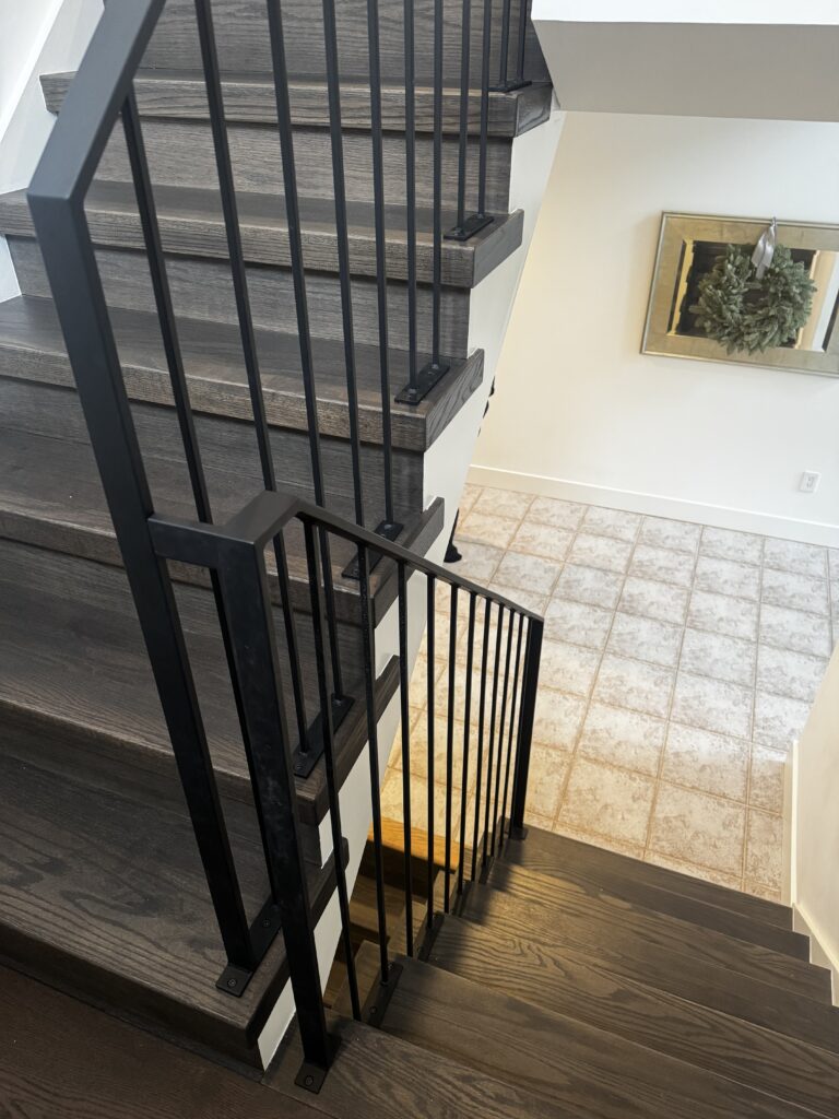 Custom fabricated wrought iron railing down a set of stairs.